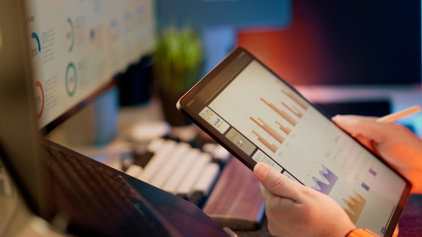 closeup of an iPad showing financial charts at an office desk